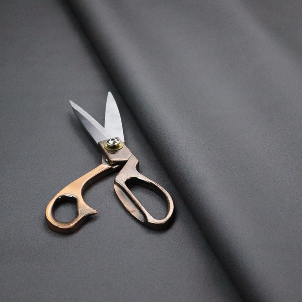 Plain, solid charcoal grey-coloured Hallstatt faux leather fabric texture with a smooth, fine finish.