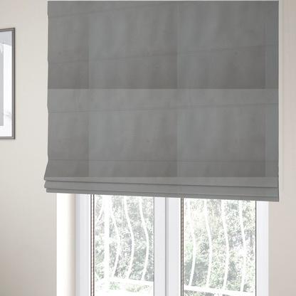The fabric used to create these Roman blinds is a plain, solid warm grey-coloured Hallstatt faux leather fabric texture with a smooth, fine finish.