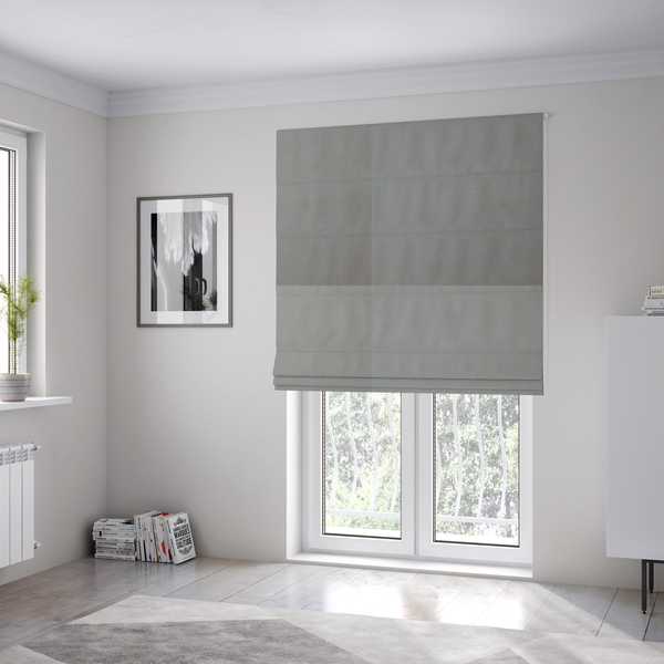 The fabric used to create these Roman blinds is a plain, solid warm grey-coloured Hallstatt faux leather fabric texture with a smooth, fine finish.