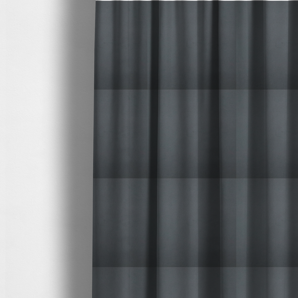 The fabric used to create these made-to-measure curtains is a plain, solid dark charcoal grey-coloured Hallstatt faux leather fabric texture with a smooth, fine finish.