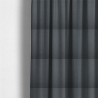 The fabric used to create these made-to-measure curtains is a plain, solid dark charcoal grey-coloured Hallstatt faux leather fabric texture with a smooth, fine finish.