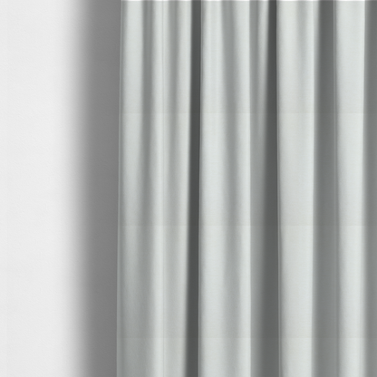 The fabric used to create these made-to-measure curtains is a solid light off-white or cream-coloured woven textile with a fine, subtle textured weave.