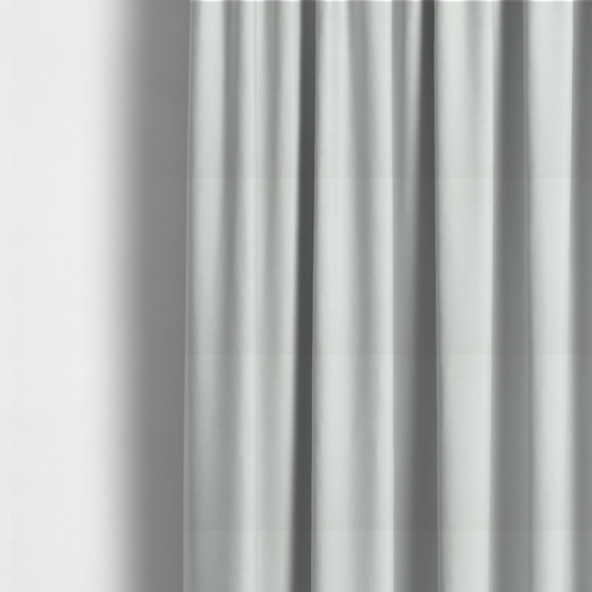 The fabric used to create these made-to-measure curtains is a solid light off-white or cream-coloured woven textile with a fine, subtle textured weave.