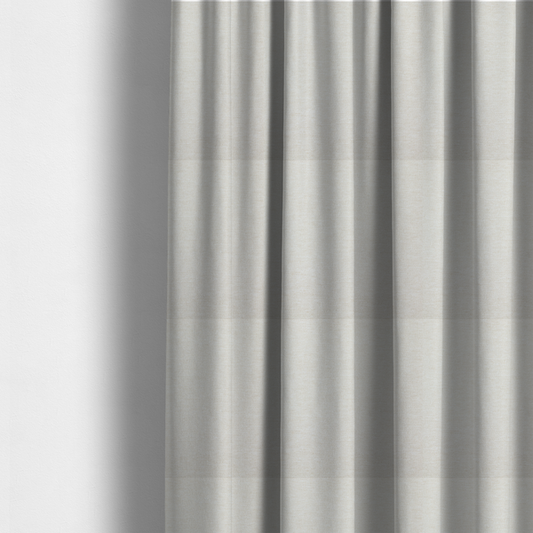 The fabric used to create these made-to-measure curtains is a solid light off-white or cream-coloured woven textile with a fine, subtle textured weave.