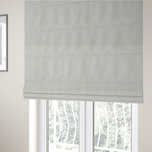 The fabric used to create these Roman blinds is a solid light off-white or cream-coloured woven textile with a fine, subtle textured weave.