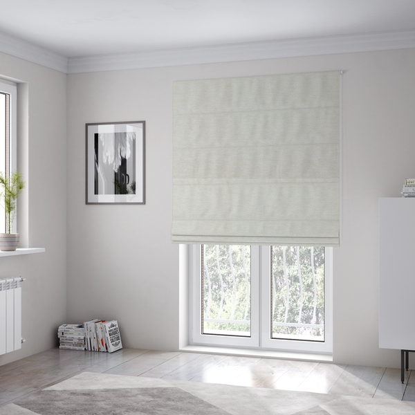 The fabric used to create these Roman blinds is a solid light off-white or cream-coloured woven textile with a fine, subtle textured weave.