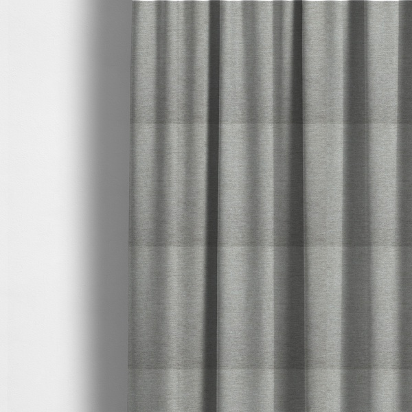 The fabric used to create these made-to-measure curtains is a solid dark beige woven textile with a fine, subtle textured weave.