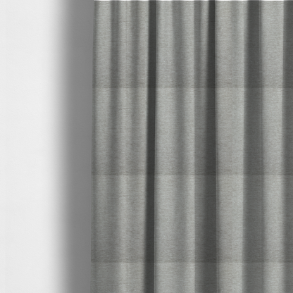 The fabric used to create these made-to-measure curtains is a solid dark beige woven textile with a fine, subtle textured weave.