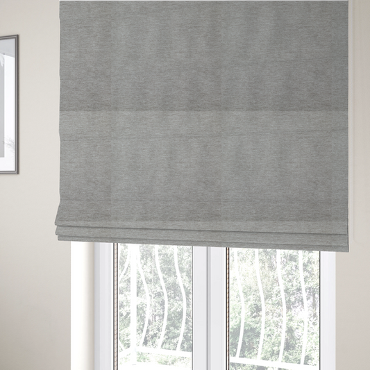 The fabric used to create these Roman blinds is a solid dark beige woven textile with a fine, subtle textured weave.