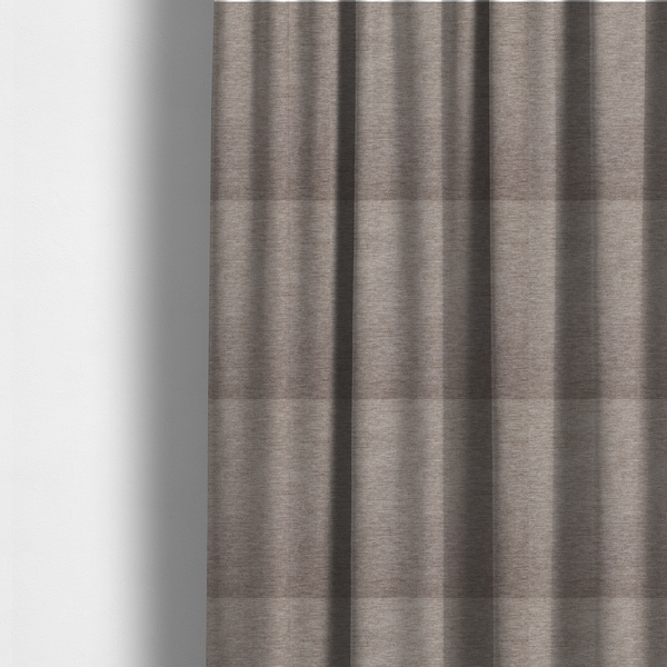 The fabric used to create these made-to-measure curtains is a solid light brown woven textile with a fine, subtle textured weave.