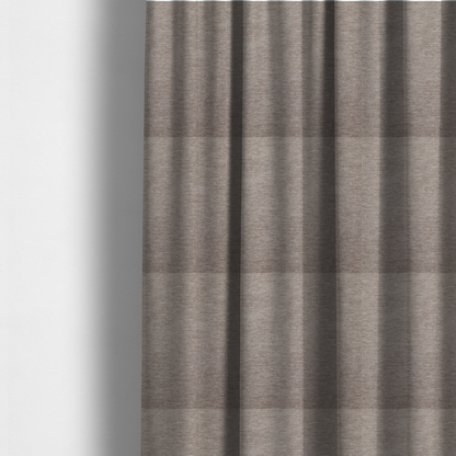 The fabric used to create these made-to-measure curtains is a solid light brown woven textile with a fine, subtle textured weave.