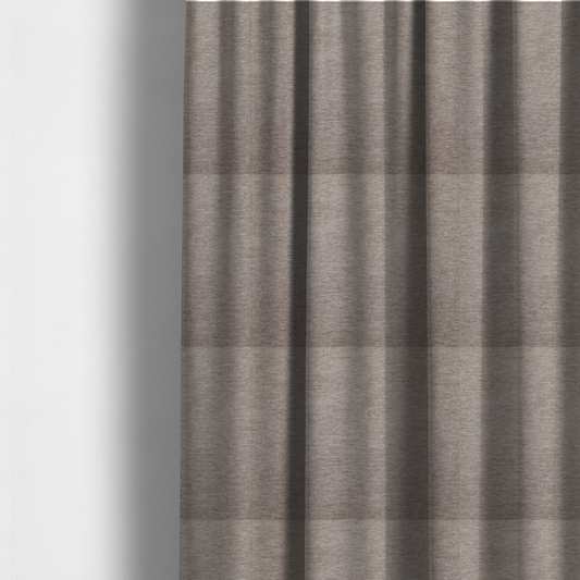 The fabric used to create these made-to-measure curtains is a solid light brown woven textile with a fine, subtle textured weave.