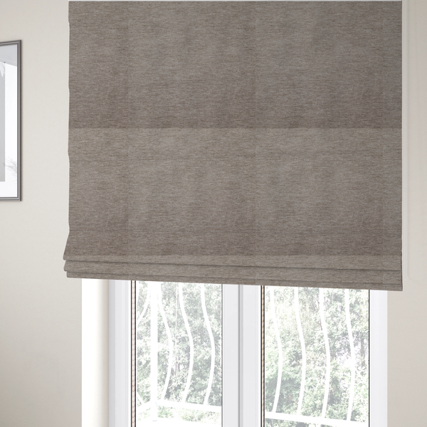The fabric used to create these Roman blinds is a solid light brown woven textile with a fine, subtle textured weave.