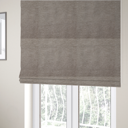 The fabric used to create these Roman blinds is a solid light brown woven textile with a fine, subtle textured weave.