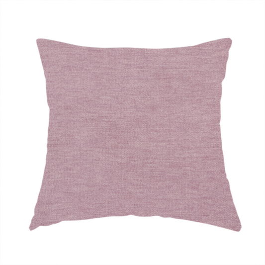 The fabric used to create this handmade cushion is a solid pink woven textile with a fine, subtle textured weave.