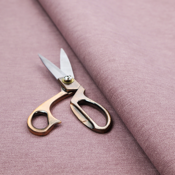 A solid pink woven textile with a fine, subtle textured weave.