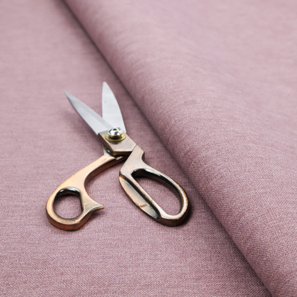 A solid pink woven textile with a fine, subtle textured weave.