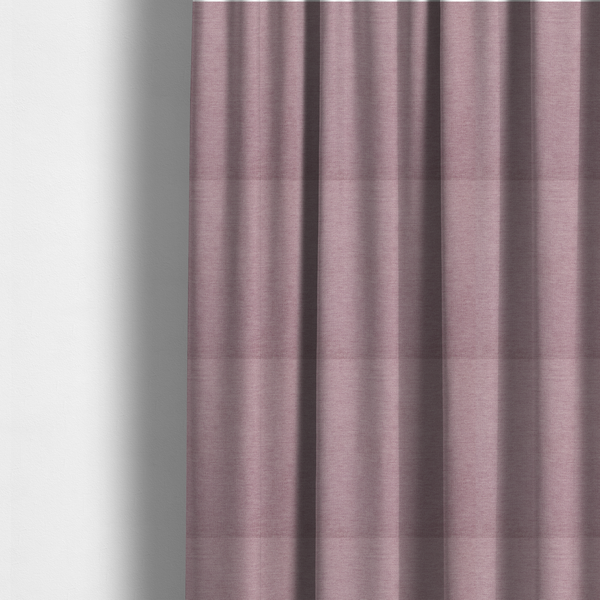 The fabric used to create these made-to-measure curtains is a solid pink woven textile with a fine, subtle textured weave.