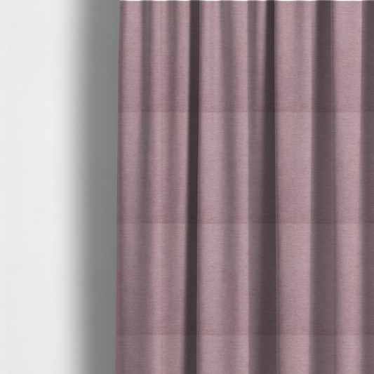 The fabric used to create these made-to-measure curtains is a solid pink woven textile with a fine, subtle textured weave.