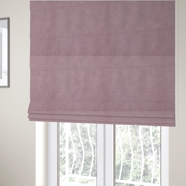 The fabric used to create these Roman blinds is a solid pink woven textile with a fine, subtle textured weave.