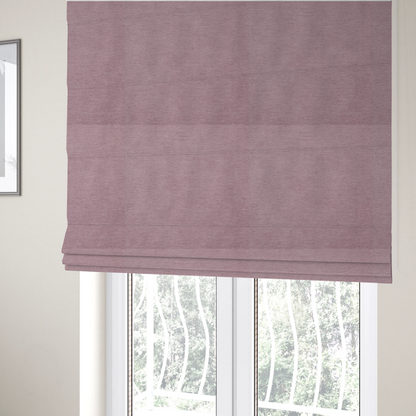 The fabric used to create these Roman blinds is a solid pink woven textile with a fine, subtle textured weave.