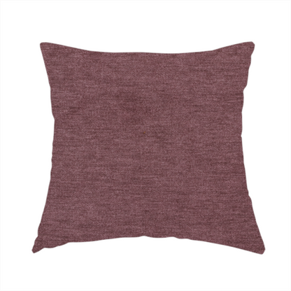 The fabric used to create this handmade cushion is a solid dark pink or mauve woven textile with a fine, subtle textured weave.