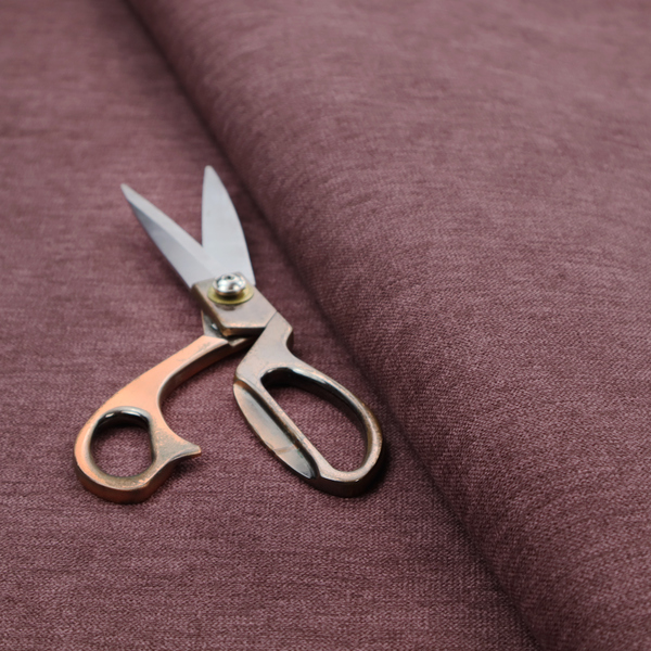 A solid dark pink or mauve woven textile with a fine, subtle textured weave.