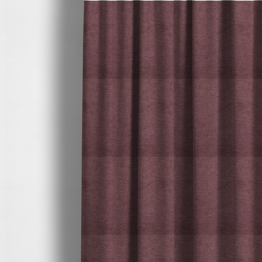 The fabric used to create these made-to-measure curtains is a solid dark pink or mauve woven textile with a fine, subtle textured weave.