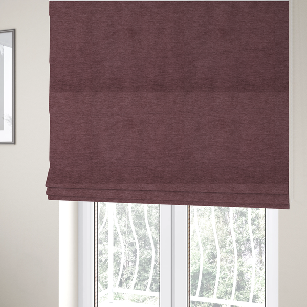The fabric used to create these Roman blinds is a solid dark pink or mauve woven textile with a fine, subtle textured weave.