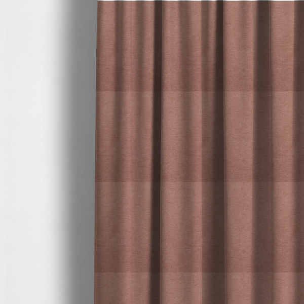 The fabric used to create these made-to-measure curtains is a solid muted pink or dusty rose woven textile with a fine, subtle textured weave.