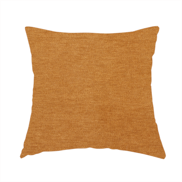 The fabric used to create this handmade cushion is a solid orange or mustard yellow woven textile with a fine, subtle textured weave.