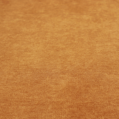 A solid orange or mustard yellow woven textile with a fine, subtle textured weave.
