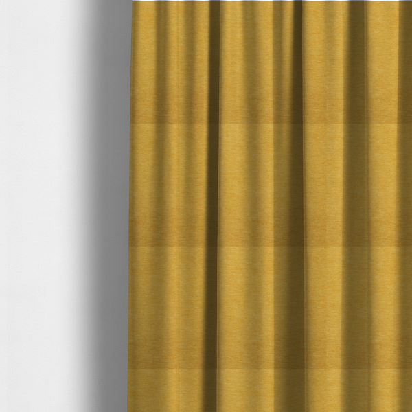 The fabric used to create these made-to-measure curtains is a solid mustard yellow woven textile with a fine, subtle textured weave.