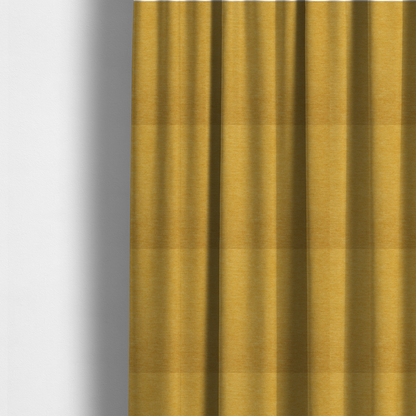 The fabric used to create these made-to-measure curtains is a solid mustard yellow woven textile with a fine, subtle textured weave.