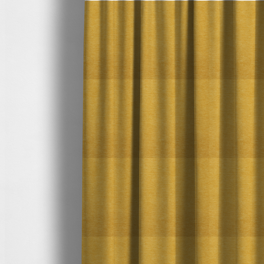 The fabric used to create these made-to-measure curtains is a solid mustard yellow woven textile with a fine, subtle textured weave.