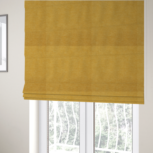 The fabric used to create these Roman blinds is a solid mustard yellow woven textile with a fine, subtle textured weave.