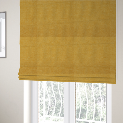 The fabric used to create these Roman blinds is a solid mustard yellow woven textile with a fine, subtle textured weave.