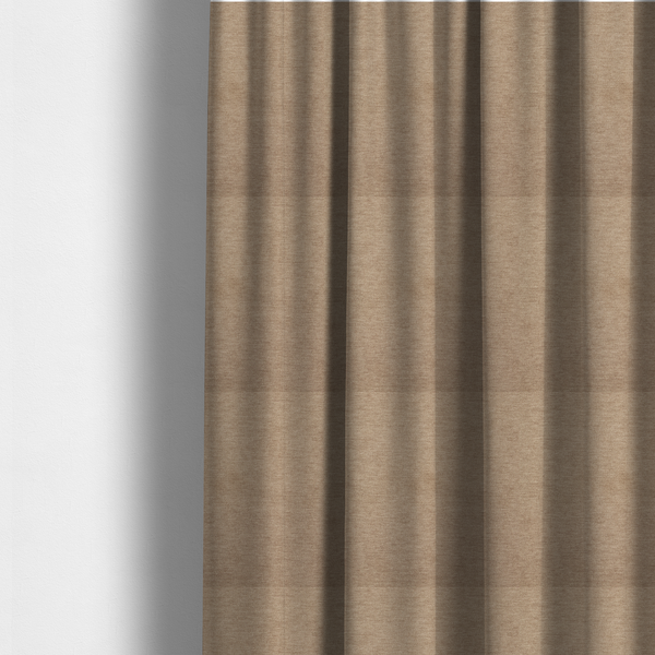 The fabric used to create these made-to-measure curtains is a solid light brown or taupe woven textile with a fine, subtle textured weave.