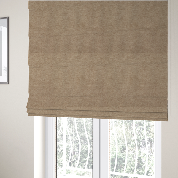 The fabric used to create these Roman blinds is a solid light brown or taupe woven textile with a fine, subtle textured weave.
