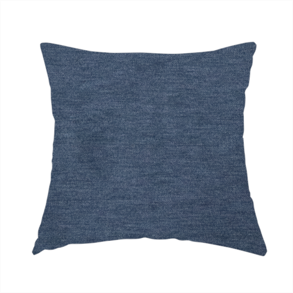 The fabric used to create this handmade cushion is a solid blue woven textile with a fine, subtle textured weave.