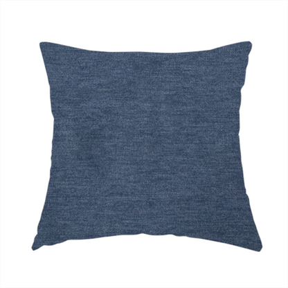 The fabric used to create this handmade cushion is a solid blue woven textile with a fine, subtle textured weave.