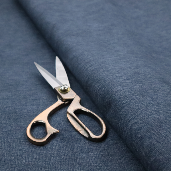 A solid blue woven textile with a fine, subtle textured weave.