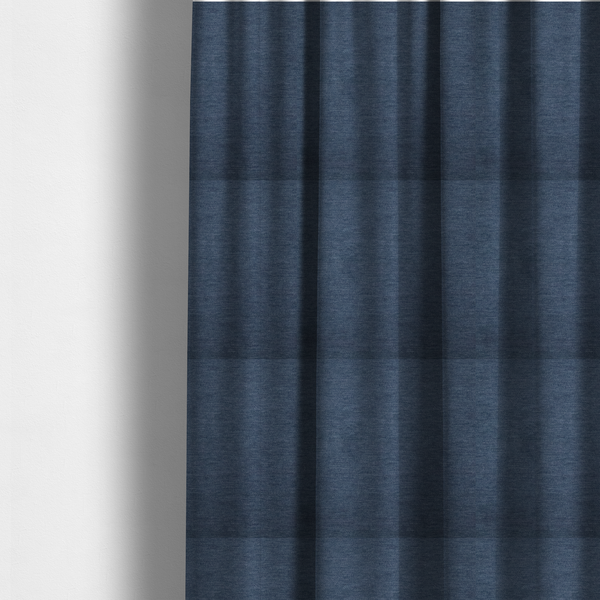 The fabric used to create these made-to-measure curtains is a solid blue woven textile with a fine, subtle textured weave.