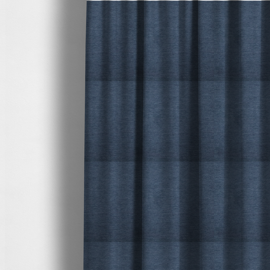 The fabric used to create these made-to-measure curtains is a solid blue woven textile with a fine, subtle textured weave.