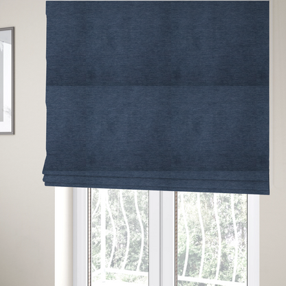 the fabric used to create these Roman blinds is a solid blue woven textile with a fine, subtle textured weave.