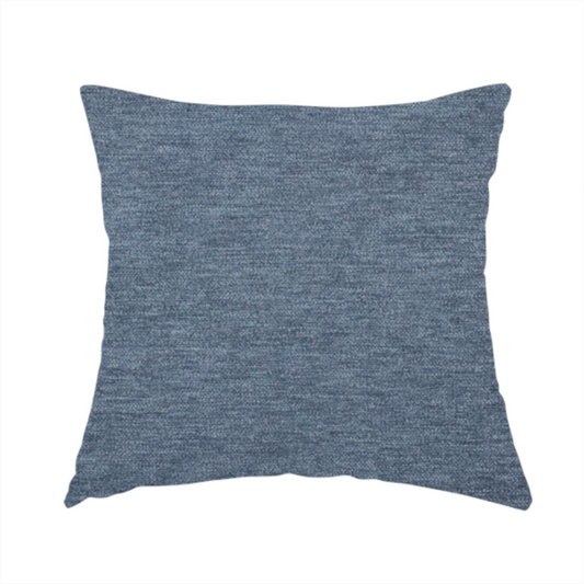 The fabric used to create this handmade cushion is a solid light blue or steel blue woven textile with a fine, subtle textured weave.