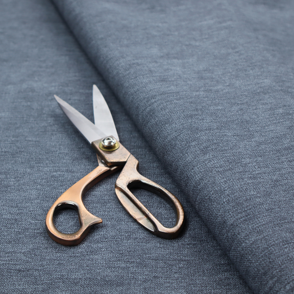 A solid light blue or steel blue woven textile with a fine, subtle textured weave.