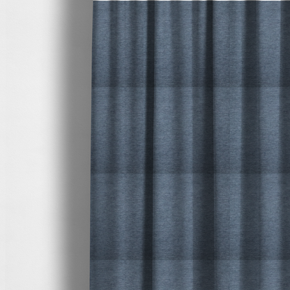 The fabric used to create these made-to-measure curtains is solid light blue or steel blue woven textile with a fine, subtle textured weave.