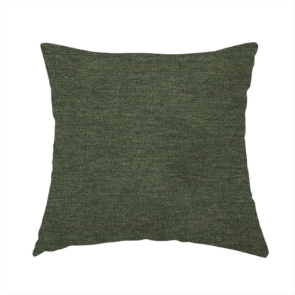 The fabric used to create this handmade cushion is a solid dark green woven fabric swatch with a fine, subtle texture.