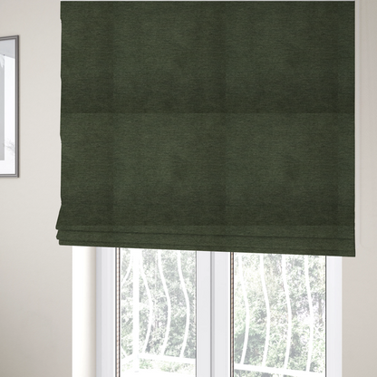 The fabric used to create these Roman blinds is a solid dark green woven fabric swatch with a fine, subtle texture.